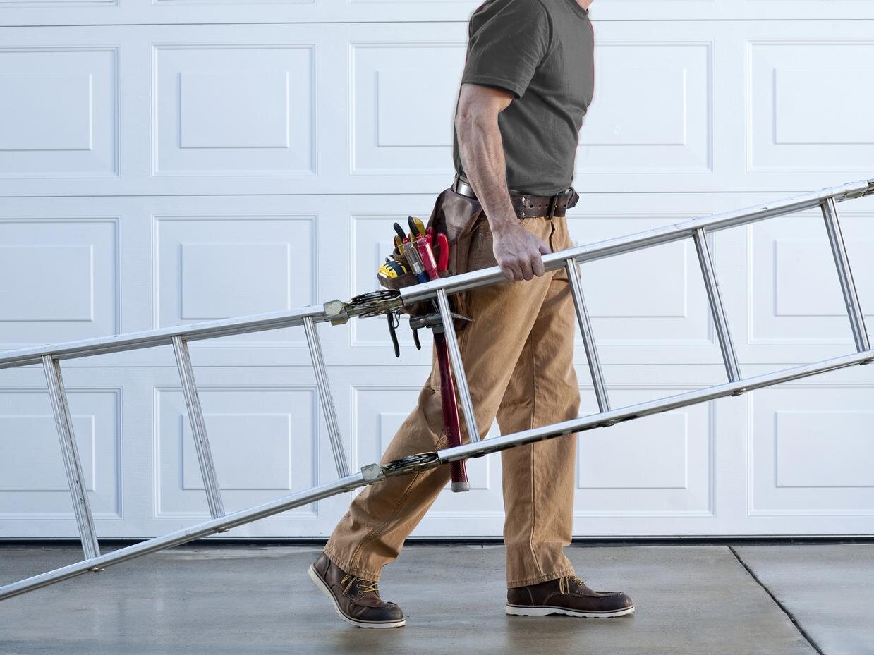 Technician repairing a garage door
